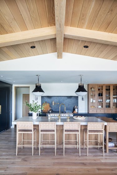 oak cabinets with wall sconces