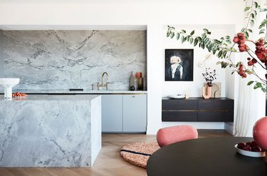 gray kitchen with marble backsplash and island