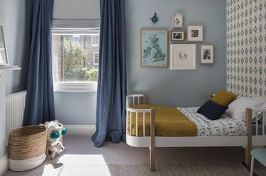 Gray-blue bedroom with blue curtains.
