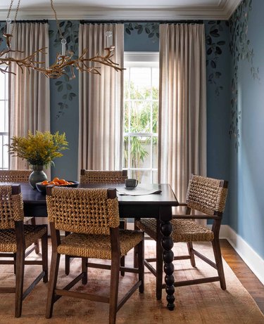 dining room with blue walls and greige curtains