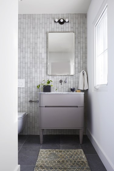 gray bathroom with purple vanity cabinet