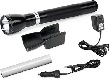 Long black MagLite flashlight with wall mount and two different charging cords for wall outlets and cars