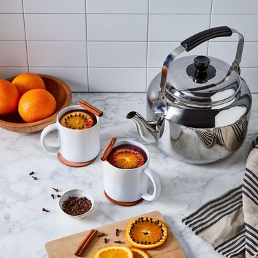 Kettle with oranges and tea