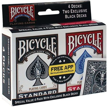 Set of four decks of classic playing cards in black and red