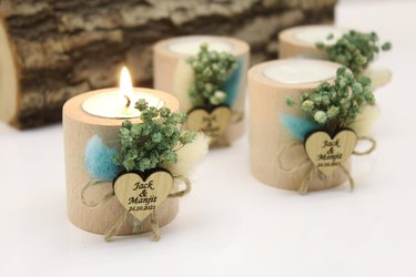 Four beige candles tied with dried flowers and heart-shaped note