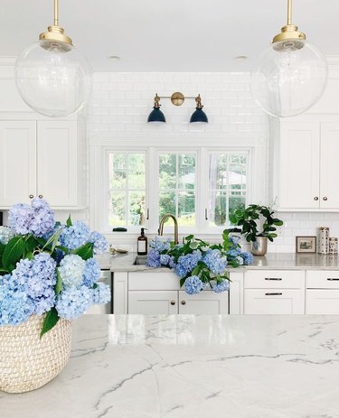 white kitchen with blue hydrangeas