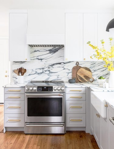 gray and white kitchen with marble backsplash