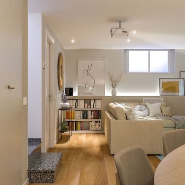 living area with shelves illuminated by lights