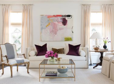 living room with champagne curtains and purple accents