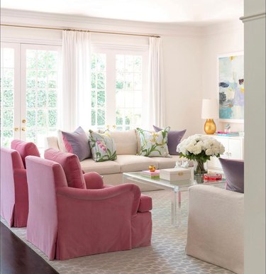 living room with champagne sofas and pink armchairs