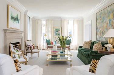 living room with green sofa and champagne curtains