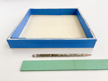 Measure and mark the painter's tape where you plan to drill holes.