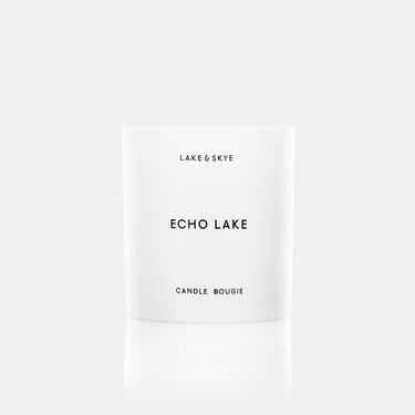 A white candle with black text that reads Echo Lake.