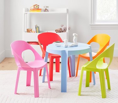Blue kids' table with four colorful chairs