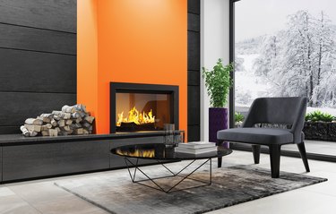 Living room with a fireplace and orange wall