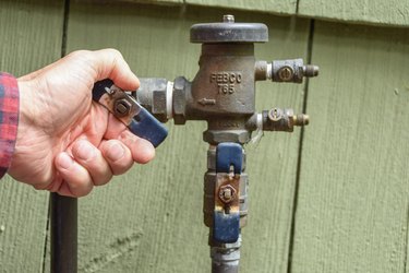 opening sprinkler system flow valve at backflow preventer