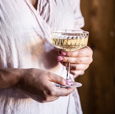 person holding champagne coupe