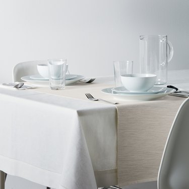 table with light linens and dishes