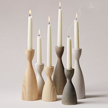 Wood candlesticks in various finishes with hourglass shape