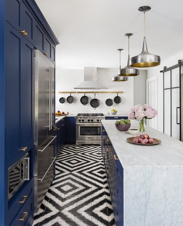 black and white tile with navy cabinets