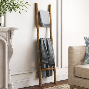 Decorative wood ladder with two throw blankets on it
