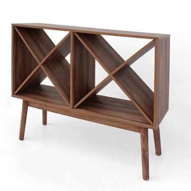 wood mid-century wine rack with long legs and two cabinets with x design in the middle