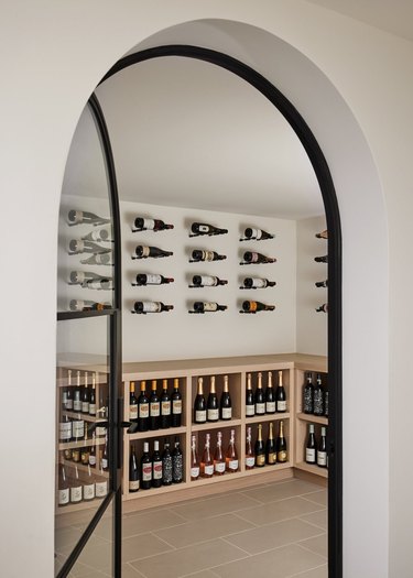 Black arched entryway to wine room