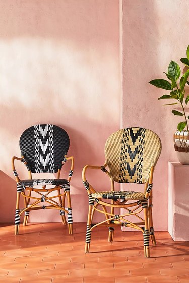 Woven chairs against pink wall