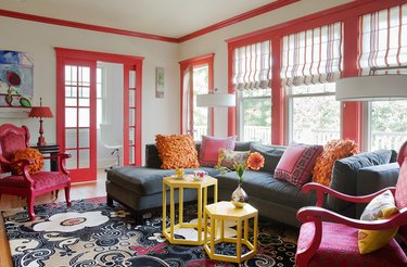A white room with coral trim on the doors and windows.