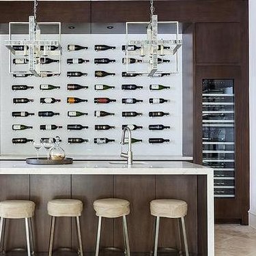 Sleek wine wall behind bar area in home