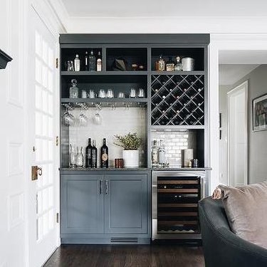 Wine room area in home featuring shelves and cabinets