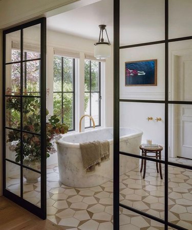 Custom marble bathtub in a white bathroom