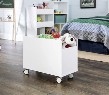 Image of a whiete storage bin with wheels filled with toys