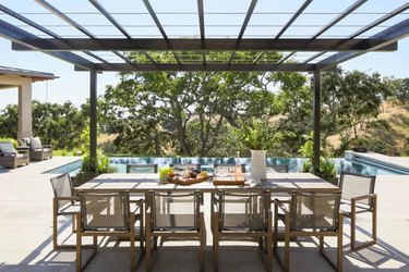 Oversized dining table overlooking pool in Santa Ynez
