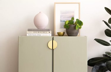 IKEA  cabinet painted green with brass handles