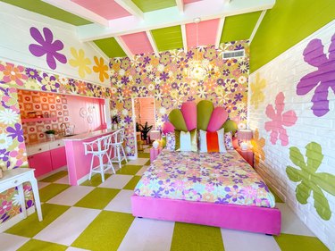 Bedroom with bright purple, pink, and green floors, ceilings, and walls.