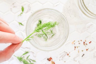 Place dill in mason jars