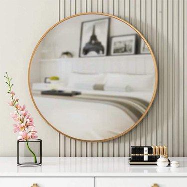 Round wall mirror with gold border
