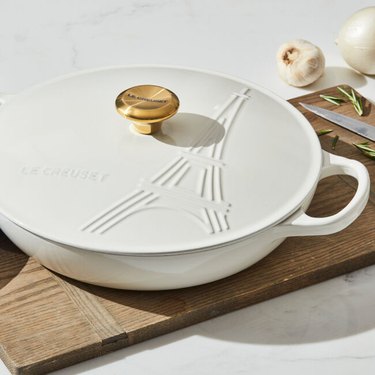 White dish with handles on a cutting board