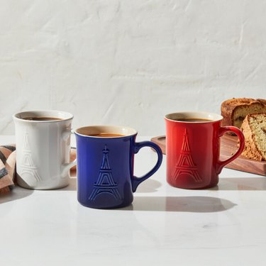Three mugs in the colors white, blue, and red