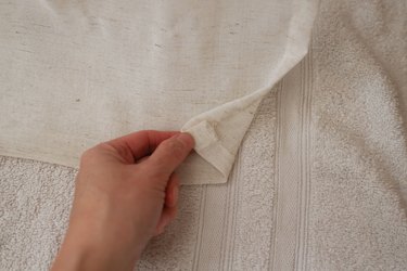 Folding one inch of raw edge under