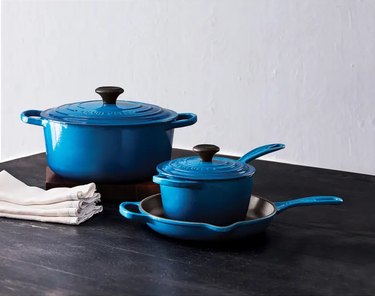 blue le creuset dutch oven, skillet, and saucepan