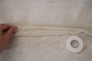 Long strip of hemming tape inserted underneath folded fabric