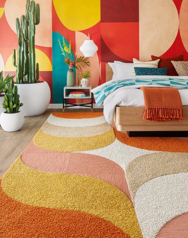 A retro inspired rug in a colorful bedroom.