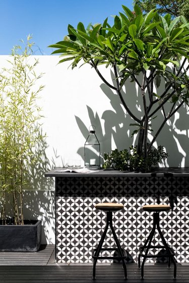 A black and white tiled backyard bar.