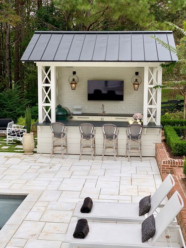 An all white shed-style outdoor bar.