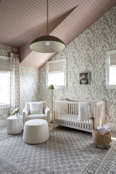 Nursery with stylish wallpaper, neutral colors, simple space