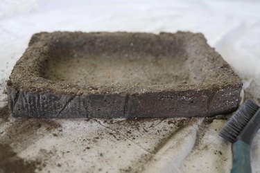 Brushing hypertufa trough with wire brush