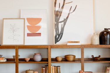 Bookshelf with books and art prints