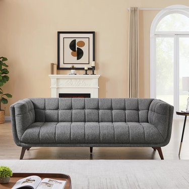 gray linen couch with stitching in living room